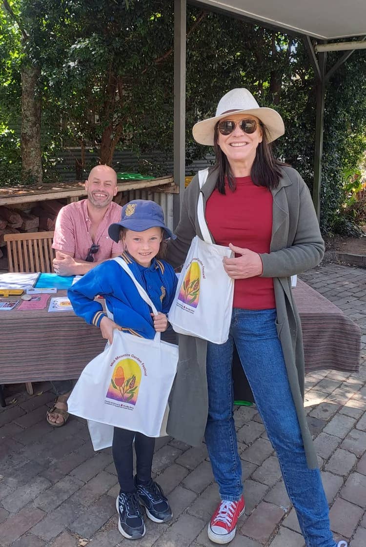 Female staff member and female student posing in front of garden
