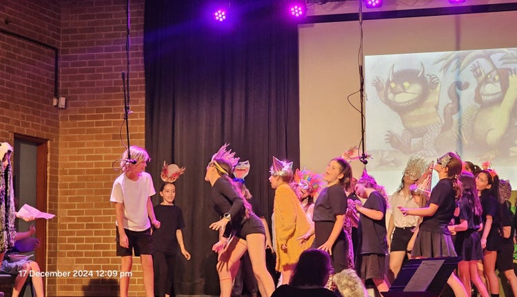 older students on stage during a theatre performance