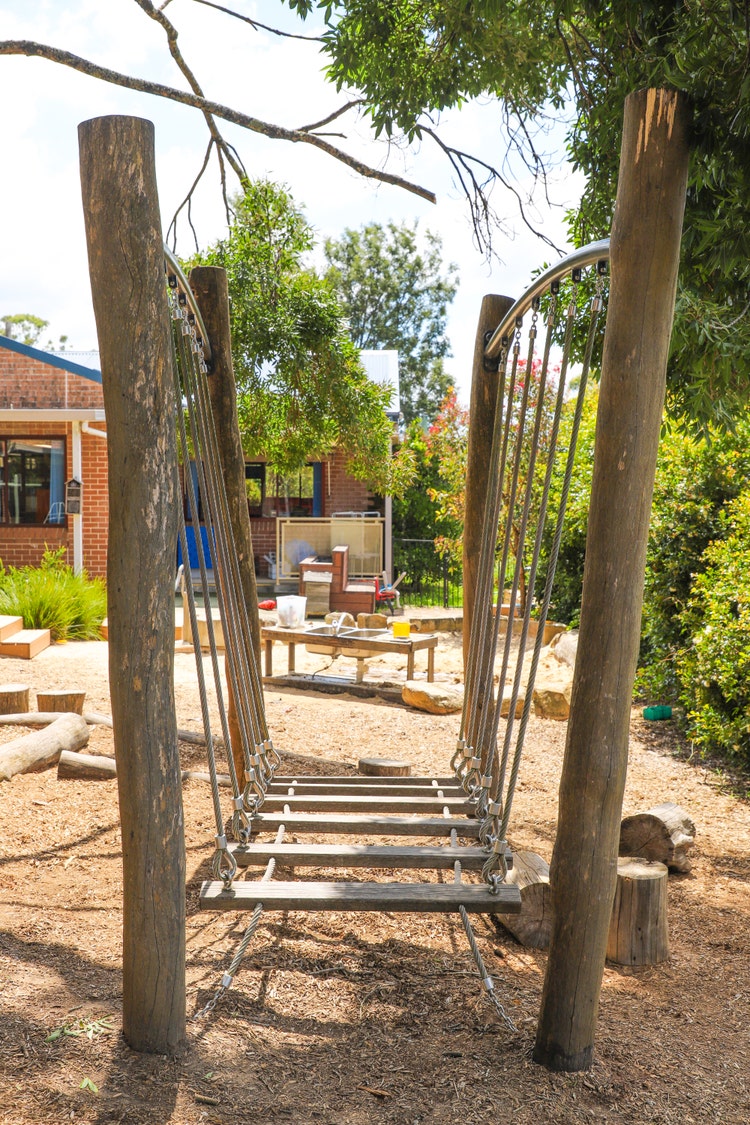 Kindergarten playground showing a log bridge